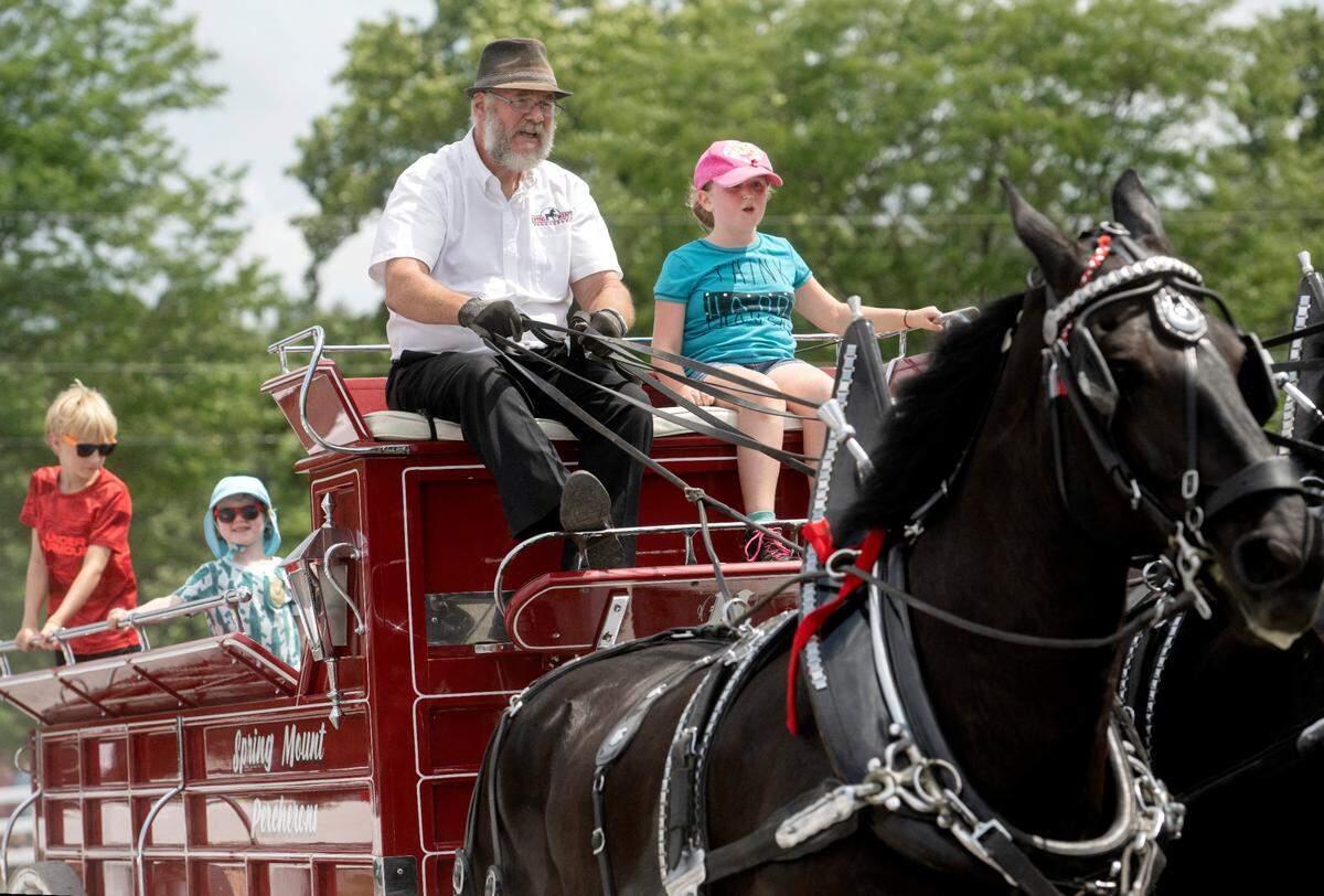 David Hershey of Spring Mount Percherons welcomes several youngsters for a ride with his 6 horse hitch during a draft horse demonstration at Penn State’s Ag Progress Days on Tuesday, Aug. 9, 2022.