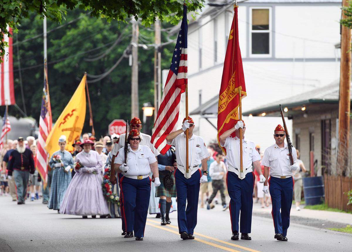 The Marine Corps League Color Guard lead the walk from the diamond to the cemetery during Boalsburg’s 154th Memorial Day Service Monday, May 28, 2018 in Boalsburg.