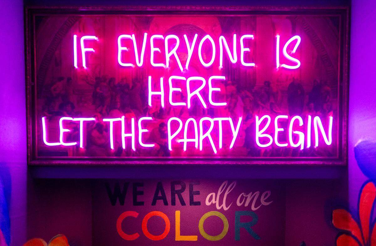 Neon signs and murals greet visitors to The Hideaway from the College Avenue entrance.
