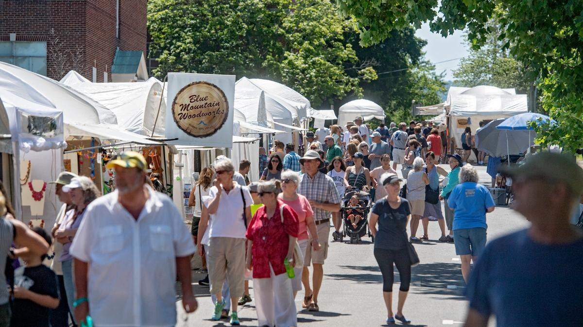 Patrons browse the artists booths on South Fraser Street during the Central Pennsylvania Festival of the Arts on Thursday, July 12, 2018.