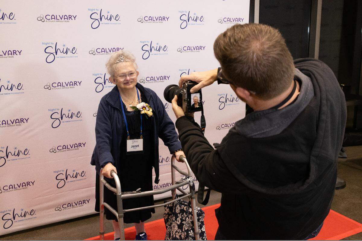 A photographer taking pictures of a participant during Night to Shine on Friday, Feb. 7, 2025.
