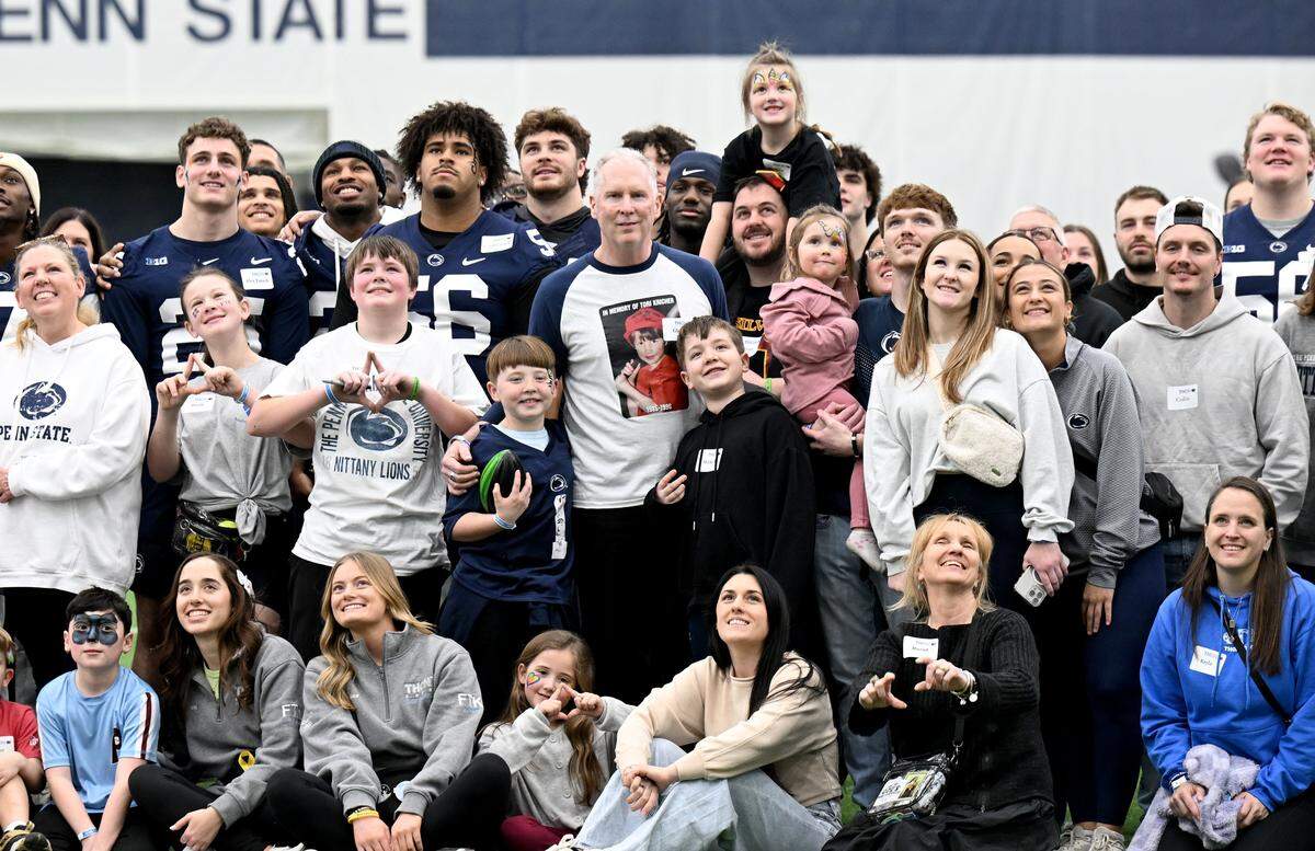 Penn State football players and Four Diamonds families gather for a photo during the Thon Explorers event at Holuba Hall on Saturday, Feb. 21, 2026.  