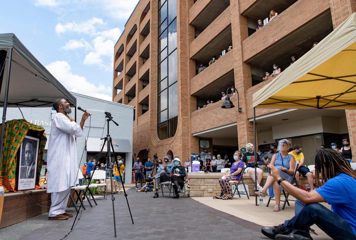 A large crowd listens, while socially distanced, to Eric Ian Farmer perform during the inaugural Juneteenth celebration hosted by the State College NAACP at MLK Plaza in State College on Friday, June 19, 2020.