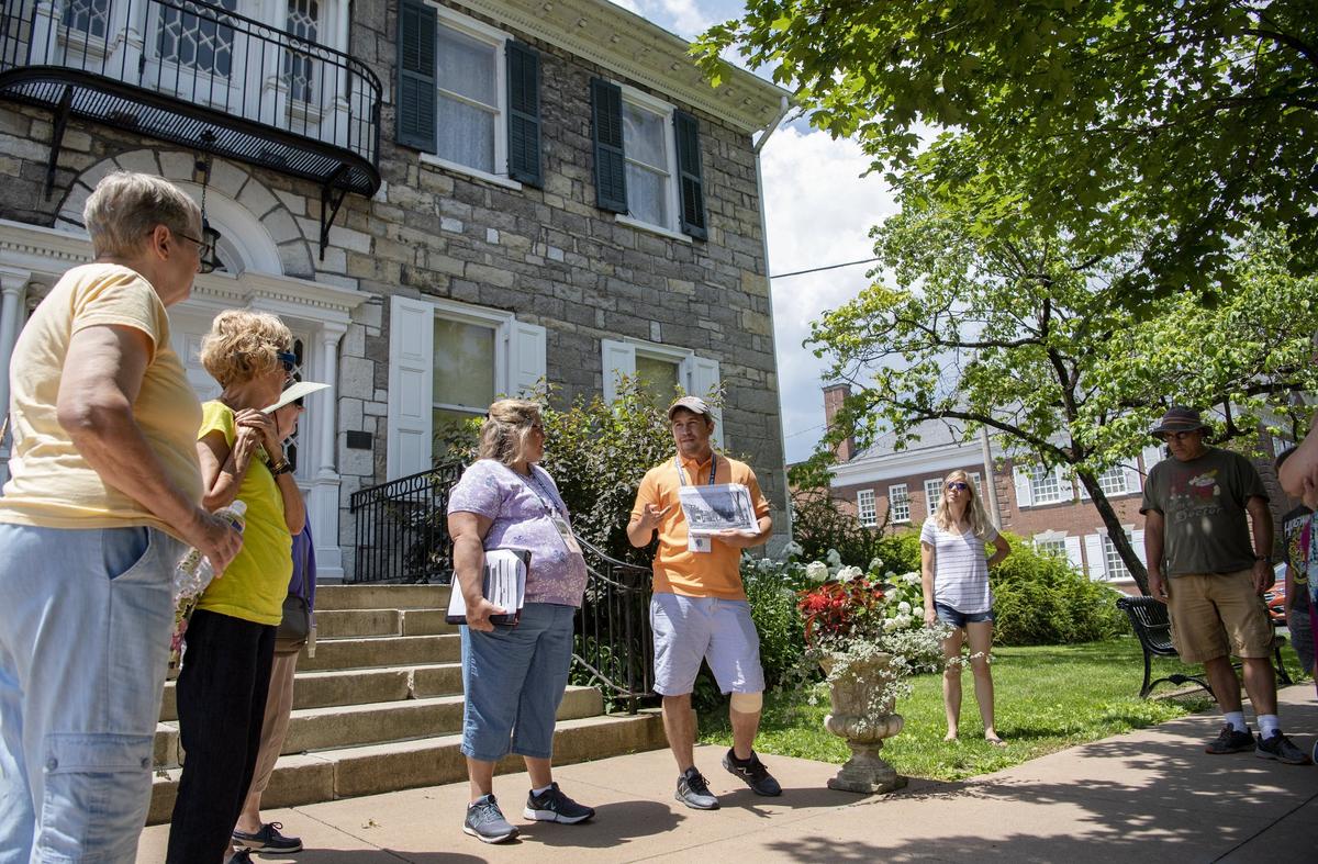 Bellefonte teachers Chris Morris and Matt Maris introduce a group to the Bellefonte Walking Tour outside of the Centre County Library and Historical Museum on Friday.