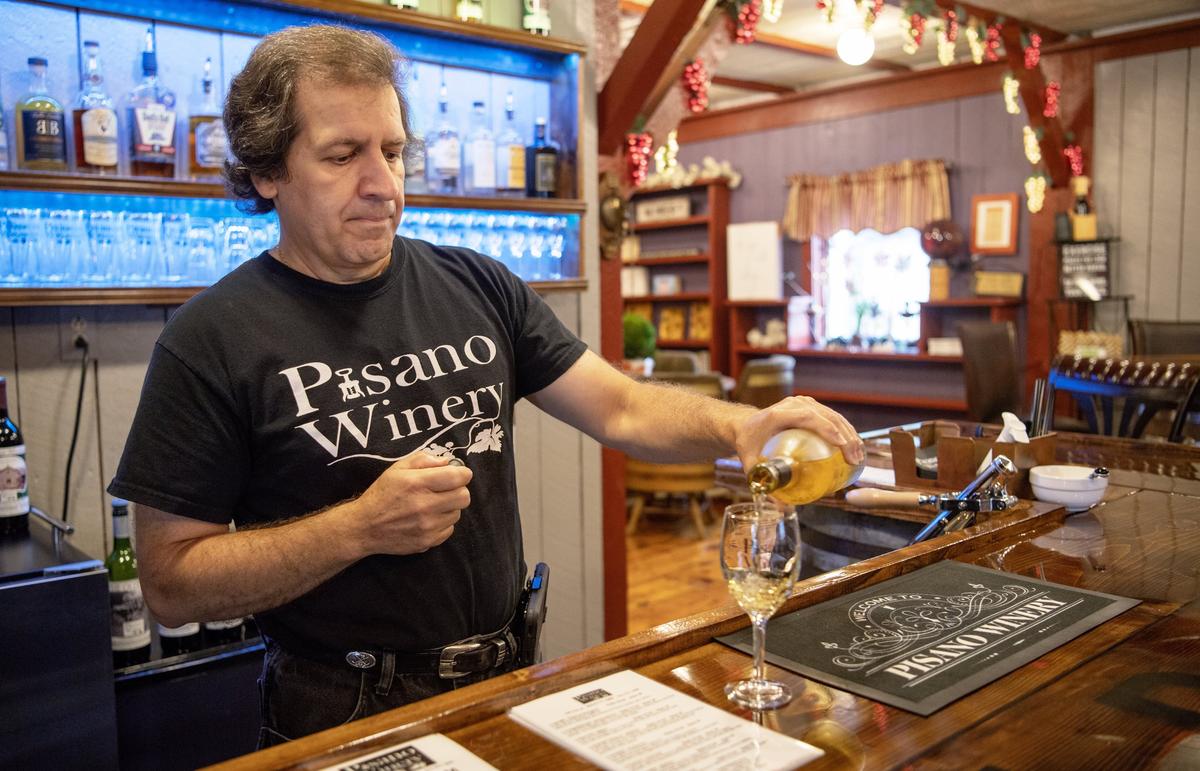 Andy Pisano pours a glass of Evil Pinot at the new Pisano Winery in Milheim on Thursday, August 22, 2019.