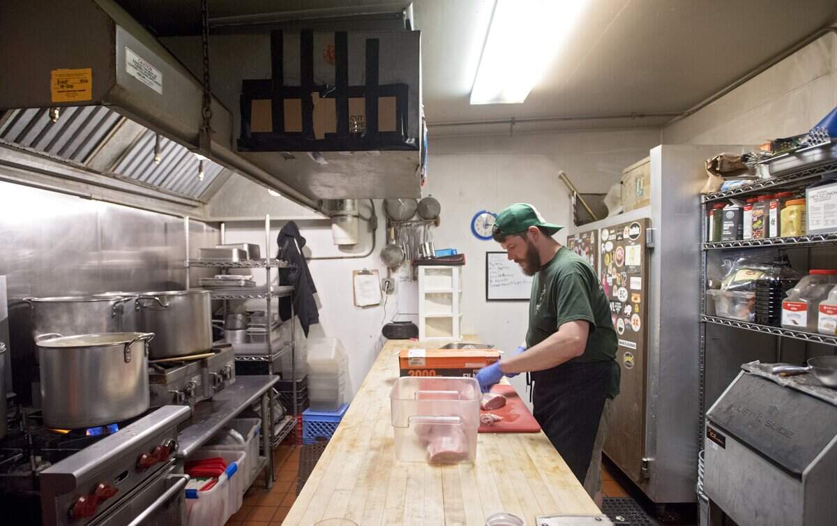 Herwig’s Austrian Bistro owner Bernd Brandstatter preps pork for jagerschnitzel in May 2018.