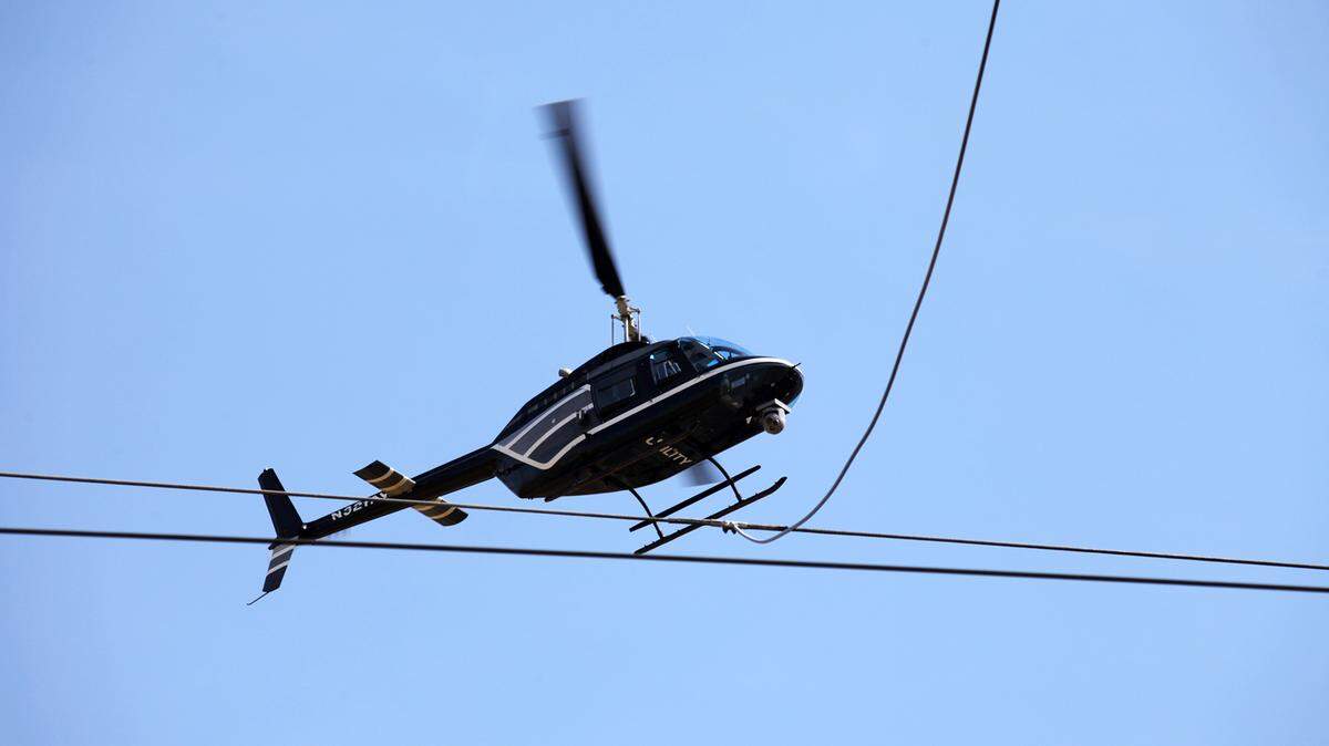 A FirstEnergy helicopter inspects a power line in this file photo.