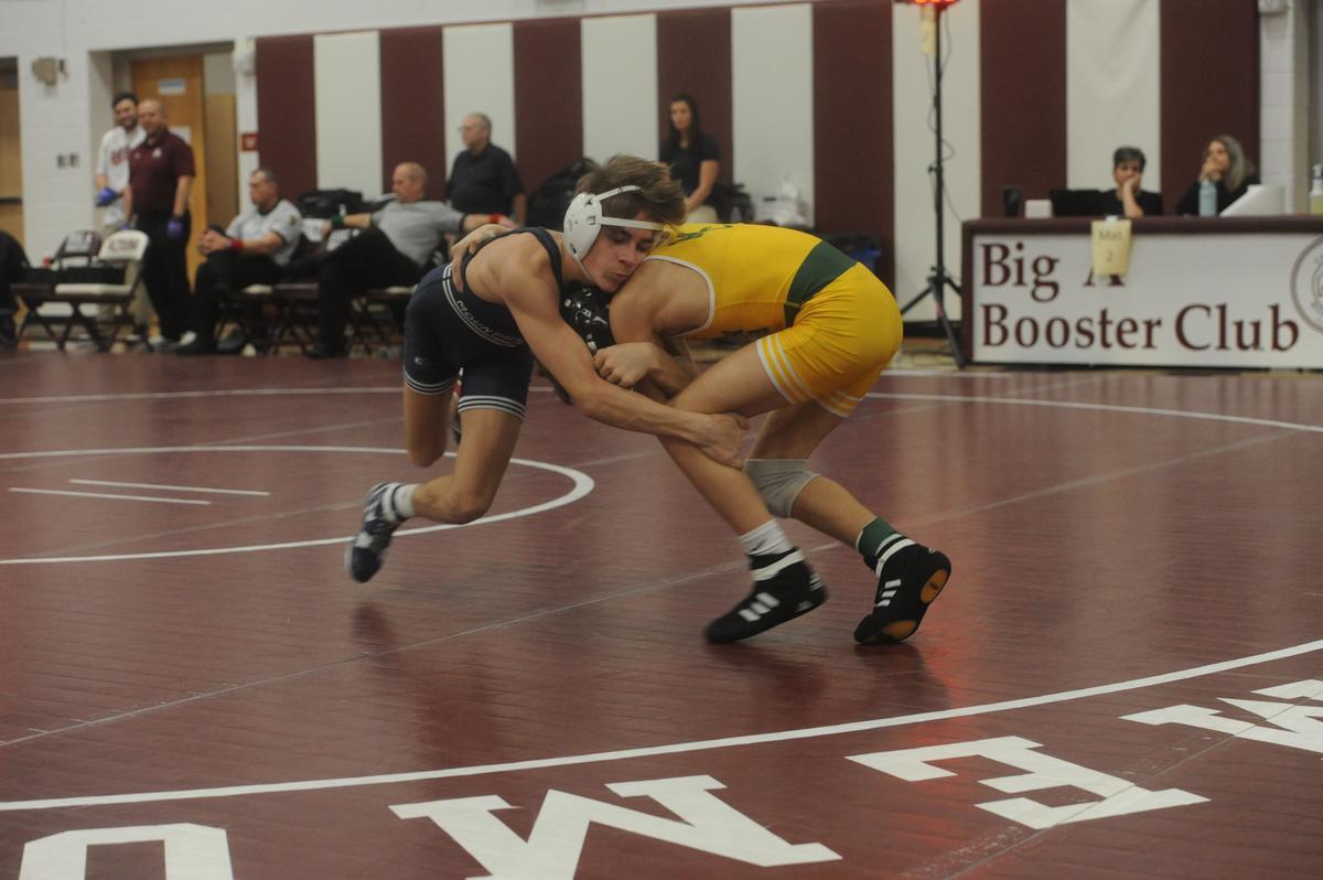 Philipsburg-Osceola’s Caleb Hummel goes for a shot on Marion Center’s Griffin Tinsman in their 107-pound quarterfinals match of the District 6 Class 2A Championships on Friday, Feb. 17, 2023 in Altoona. Hummel beat Tinsman, 8-2.