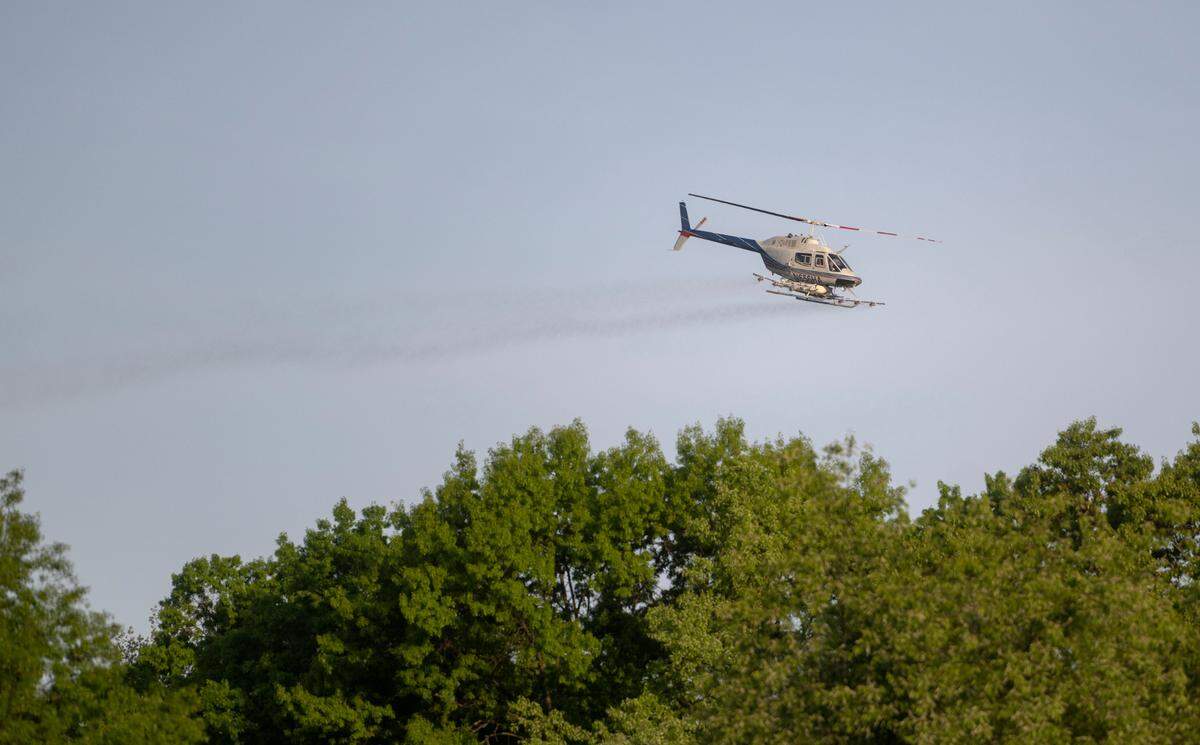 A helicopter spraying to help control spongy moth caterpillar activity passes over the Oakwood neighborhood in Patton Township on Tuesday, May 16, 2023.