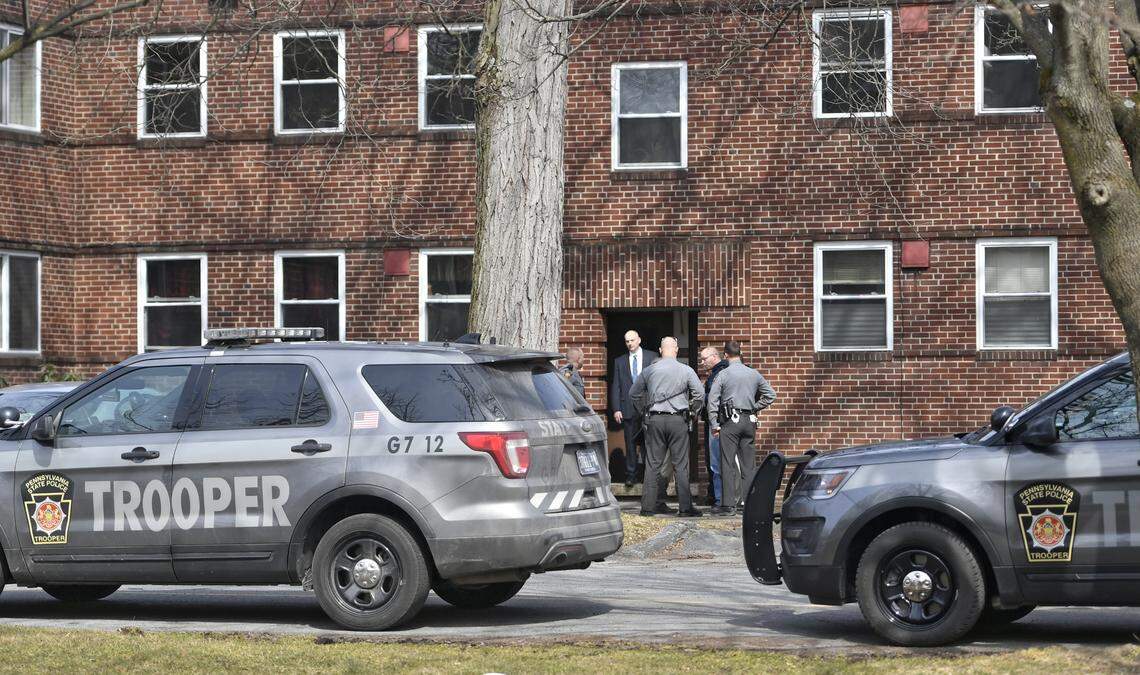 State College Police officers, Pennsylvania State Police officers, and detectives talk outside of Marvin Gardens apartment after the shooting of Osaze Osagie on March 20.