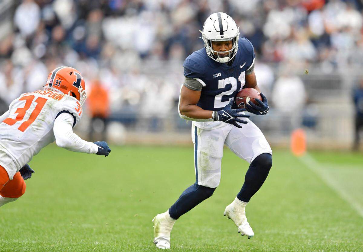 Penn State running back Noah Cain makes a catch and runs from an Illinois defender during the first overtime of the game on Saturday, Oct. 23, 2021.