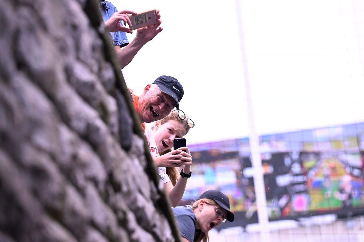 Family and friends cheer for the participants in the Ironman 70.3 Pennsylvania Happy Valley as they run through the South end zone tunnel of Beaver Stadium to the finish line on Sunday, July 2, 2023.
