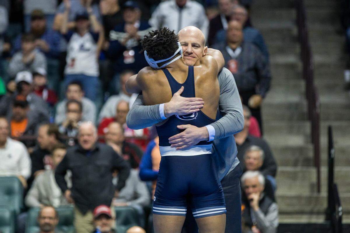 Penn State head coach Cael Sanderson hugs Penn State wrestler Carter Starocci after he defeated Nebraska wrestler Mikey Labriola in the 174 pound weight class finals match during the NCAA Wrestling Championships at the BOK Center. 