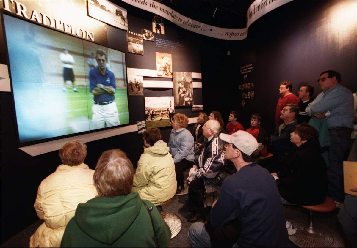 Visitors watch a video on Penn State sports history on the opening day of the Penn State All-Sports Museum on Feb. 17, 2002.