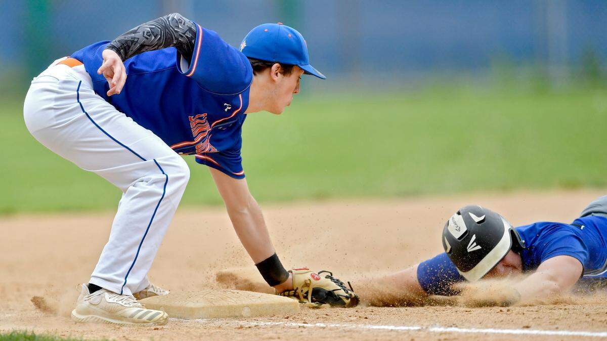 Saint Joseph’s Chris Forstmeier tags out a Williamsport runner as he tries to steal third during the District 6 A playoff game on Tuesday, May 24, 2022.