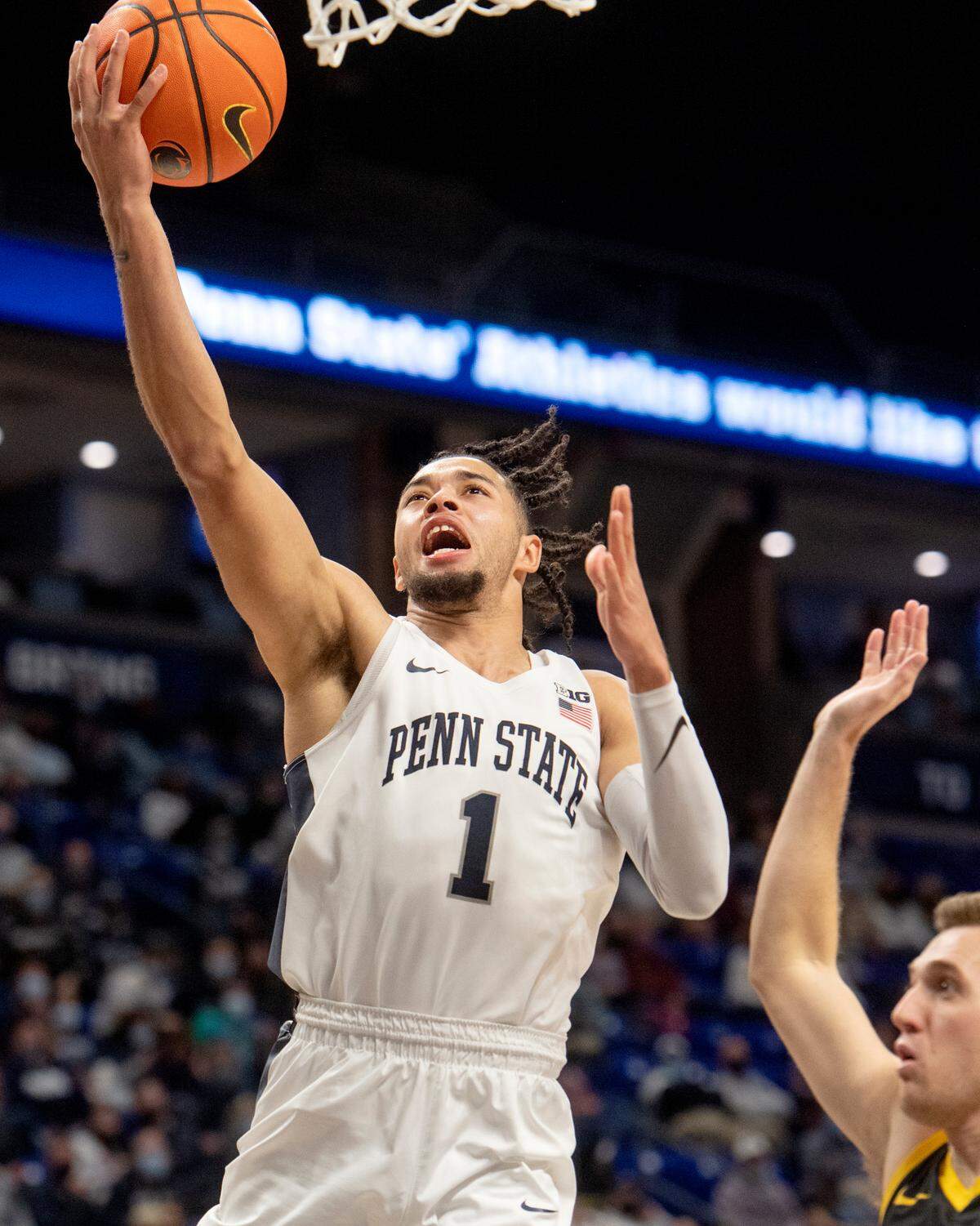 Penn State’s Seth Lundy goes in for a basket ahead of Iowa defenders during the game on Monday, Jan. 31, 2022.