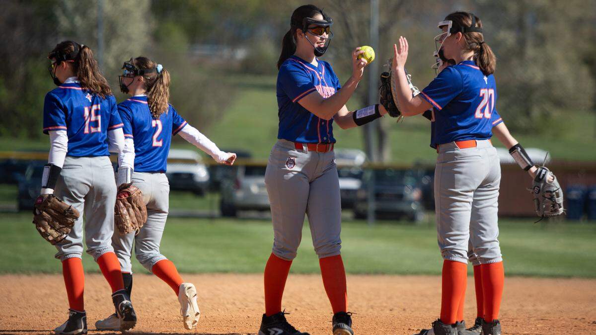 Saint Joseph’s Elizabeth Weller (11) and Saint Joseph’s Jordyn Rose (20) high-five before an inning during a high school softball game between Saint Joseph’s Catholic Academy and Bucktail High School at Hess Field on Monday, April 26, 2021 in State College, Pa.