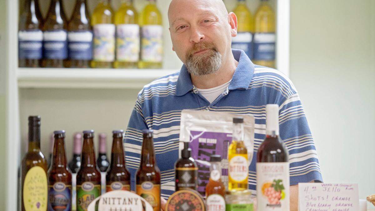 Owner of The Branch and The Vine Tom Tate stands on June 27 with some of the local artisan products he sells in his shop and that participate in the monthly State College Culture Crawl & Festival.
