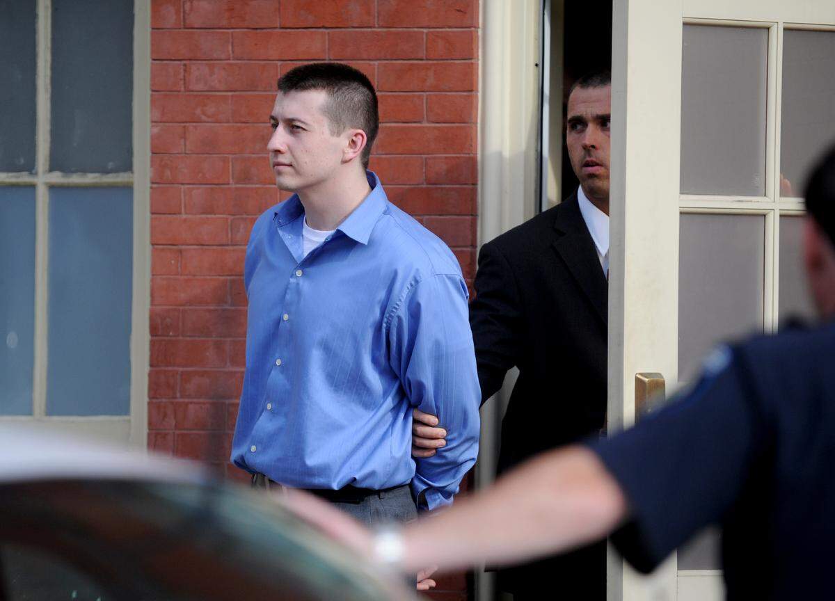 Dmitriy Litvinov is escorted out of the Centre County Courthouse annex in 2012 after being found guilty for a rash of violent robberies and burglaries.