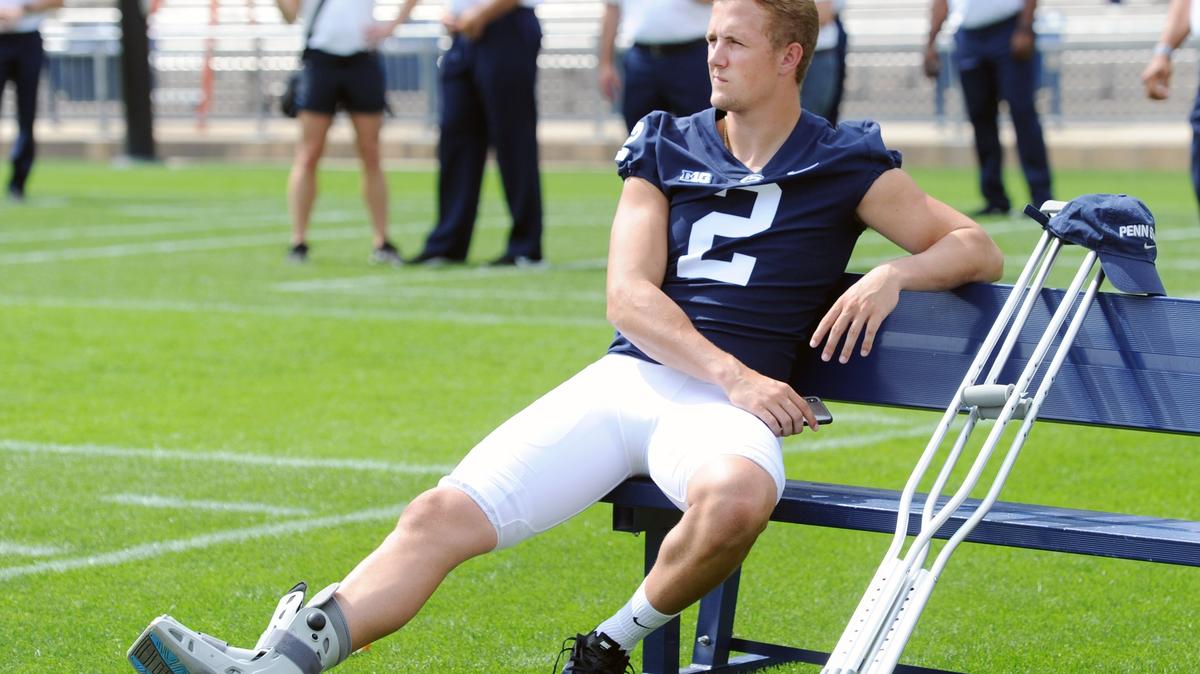 Penn State quarterback Tommy Stevens wears a boot on his right foot during Penn State football photo day Saturday at Beaver Stadium.