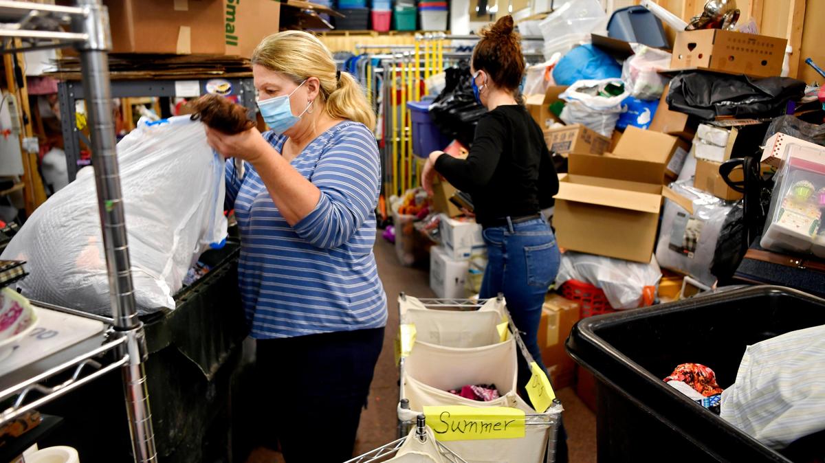Faith Centre thrift store manager Donna Spicer sorts through items donated May 18, 2020. The organization accepts donations of clothing, food and pet food for those in need.