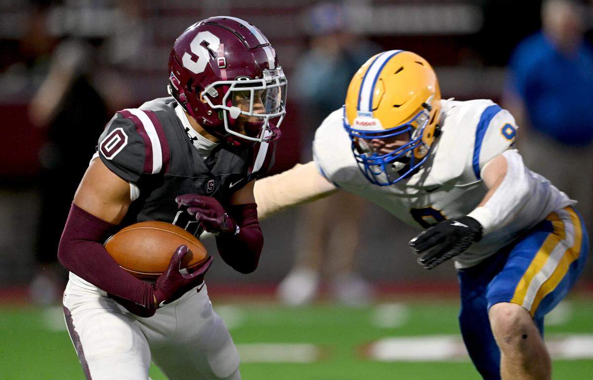 State College’s D’Antae Sheffey tries to avoid a Downingtown East defender during the game on Friday, Sept. 1, 2023.
