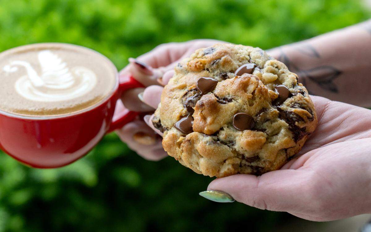 A chocolate chip walnut cookie from Pouf Patisserie. The latte art was by Redha Alajmi.