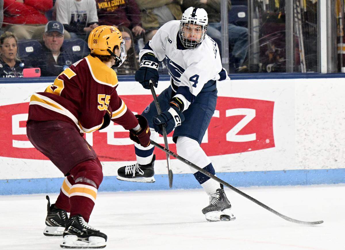 Penn State's Mac Gadowsky makes a pass around a Minnesota defender during the game on Wednesday, March 11, 2026 at Pegula Ice Arena. 