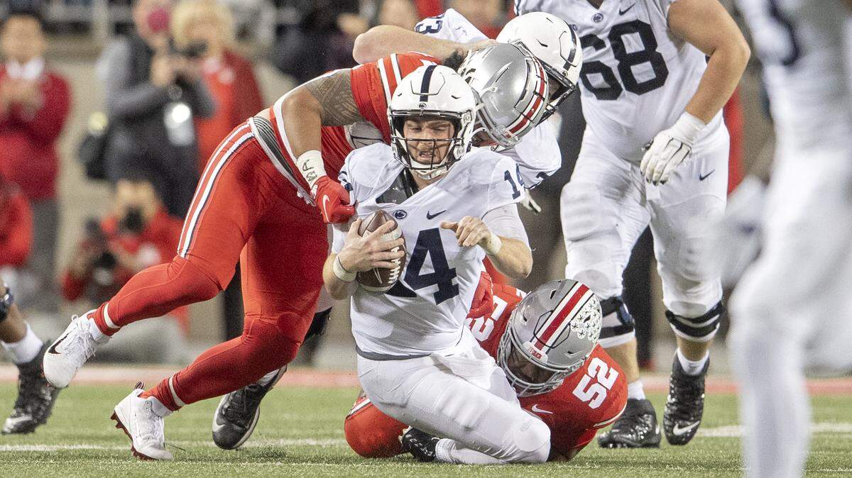 Ohio State defenders sack Penn State quarterback Sean Clifford during the game on Saturday, Oct. 30, 2021 at Ohio Stadium.