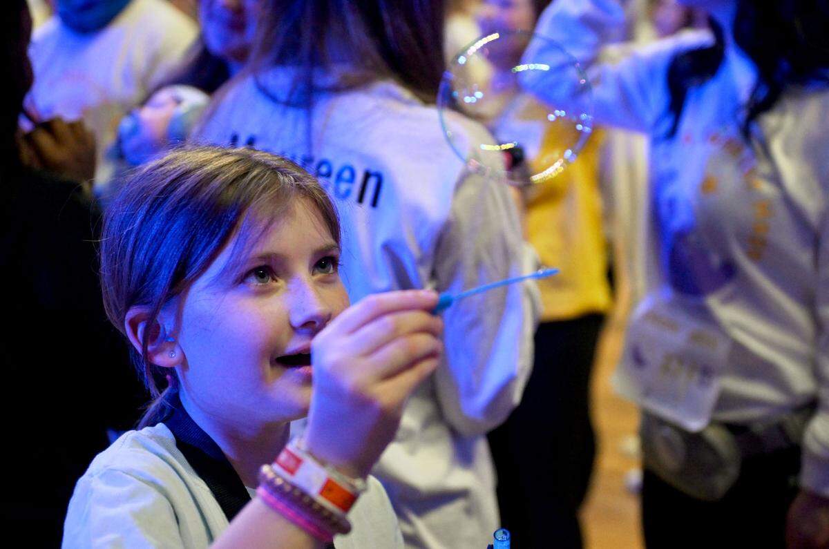 Brielle Maurer, 10, plays with bubbles during Penn State Thon on Friday, Feb. 21, 2025.