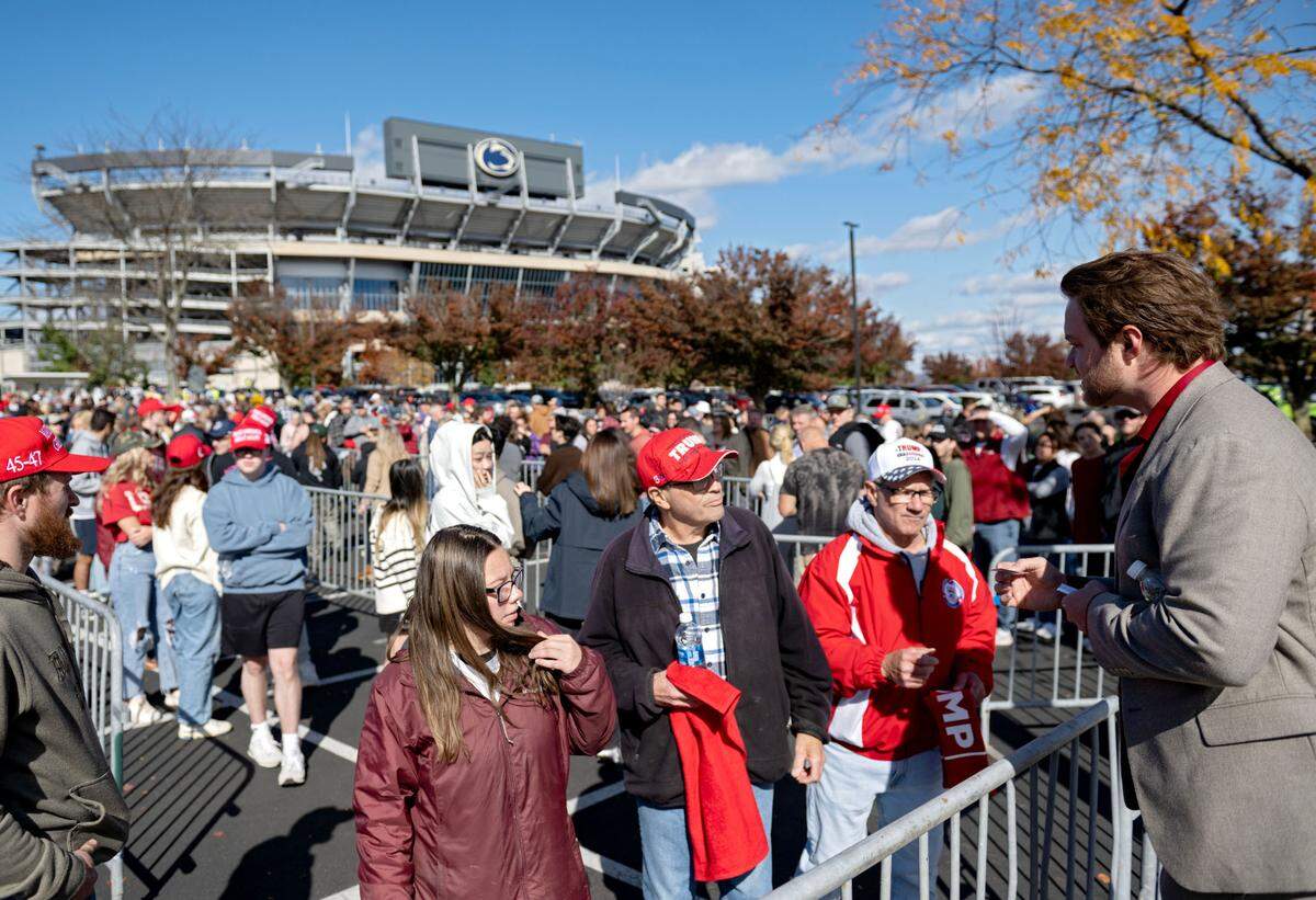 Grant Martin, who is a write-in candidate for the 15th Congressional District, talks to Trump supporters as they line up to enter the Bryce Jordan Center for a rally on Saturday, Oct. 26, 2024.