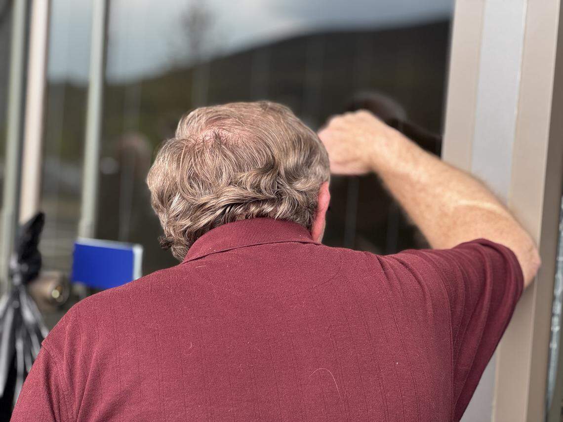 A man peers inside Happy Valley Casino’s glass doors as he waits for the casino to open April 24, 2026.