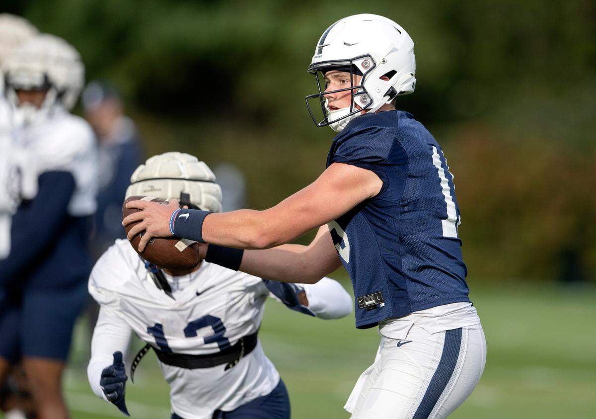 Penn State quarterback Drew Allar hands the ball off during practice on Wednesday, Sept. 28, 2022.