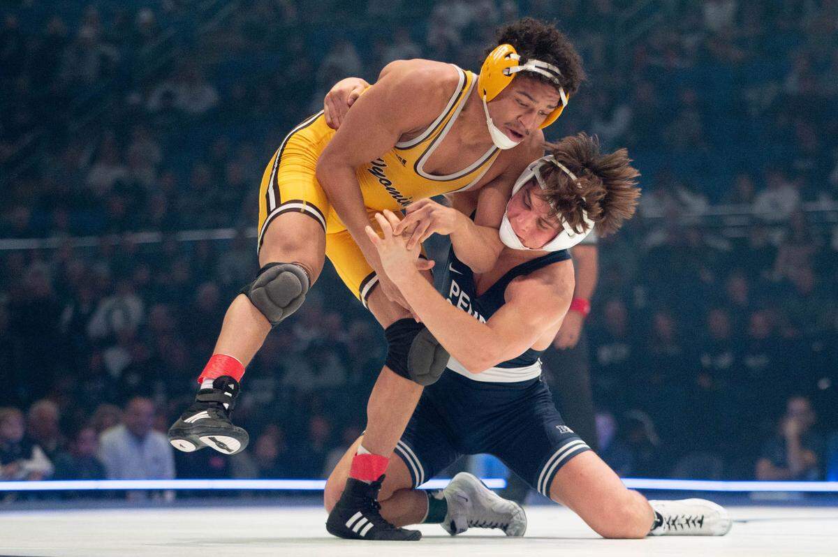 At 157, Tyler Kasak, right, wrestles Jared Hill, left, during the dual meet between Penn State and Wyoming on Sunday, Dec. 15, 2024.