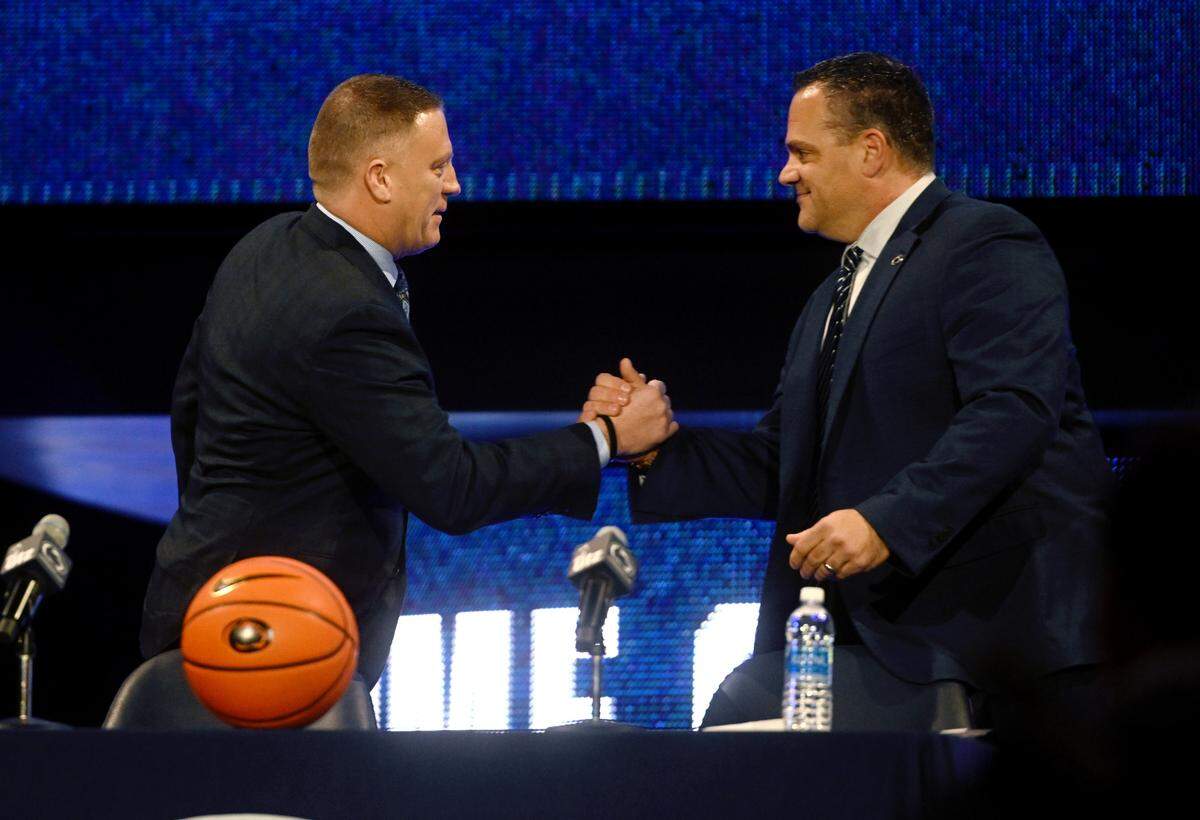 Mike Rhoades shakes hands with Penn State athletic director Pat Kraft after being introduced as the new Penn State men’s basketball coach during a press conference at the Bryce Jordan Center on Thursday, March 30, 2023.