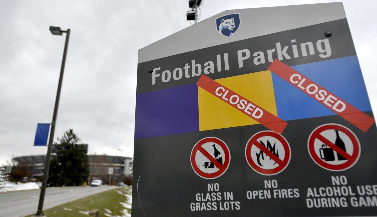 A sign for football parking along Porter Road has several types of parking pass colors as being closed. Grass parking lots for the Penn State football game this weekend will be closed due to the amount of precipitation the region has had.