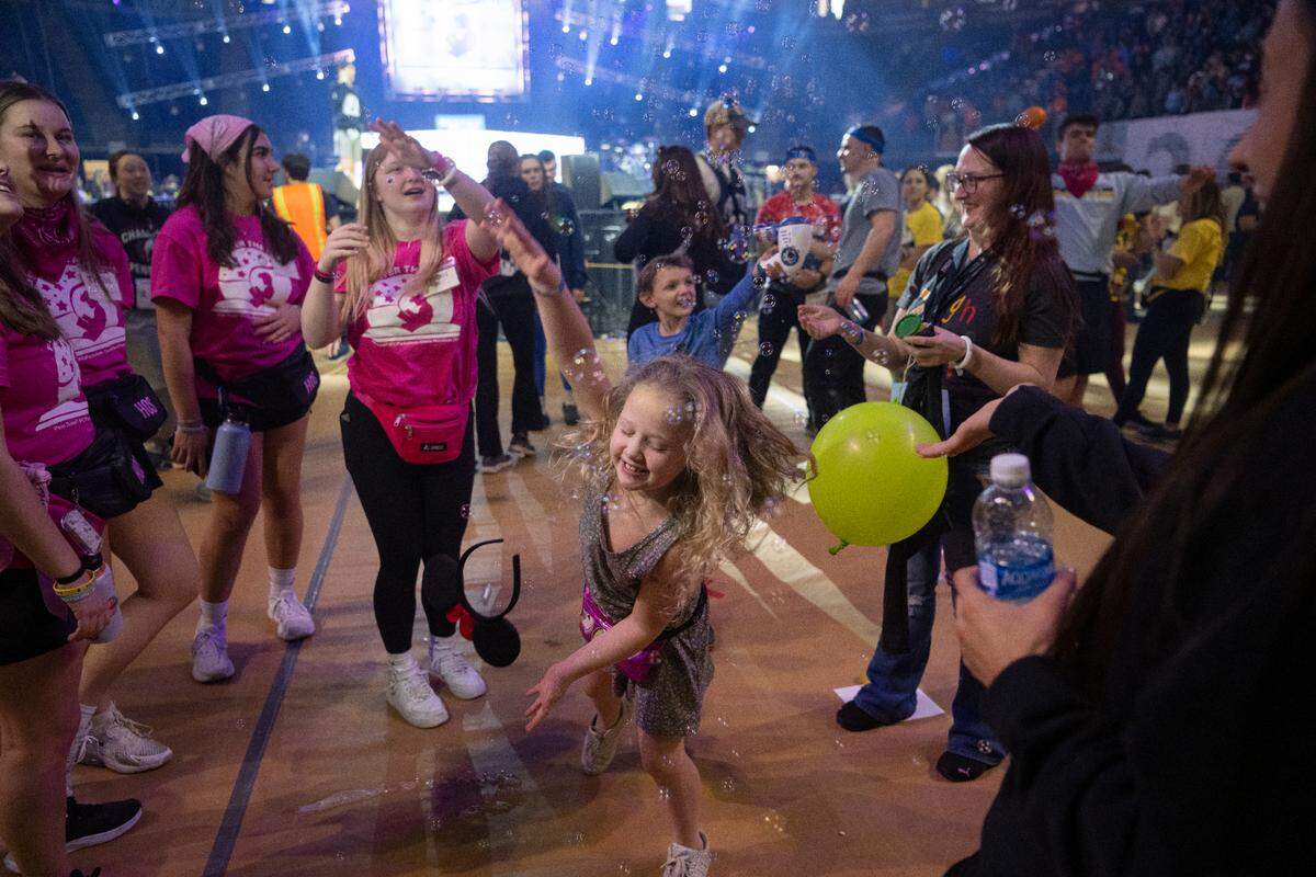 Jocelynn McKee, 6, dances through bubbles as she plays with Thon volunteers during the Penn State IFC/Panhellenic Dance Marathon on Saturday Feb. 18, 2023 at the Bryce Jordan Center.