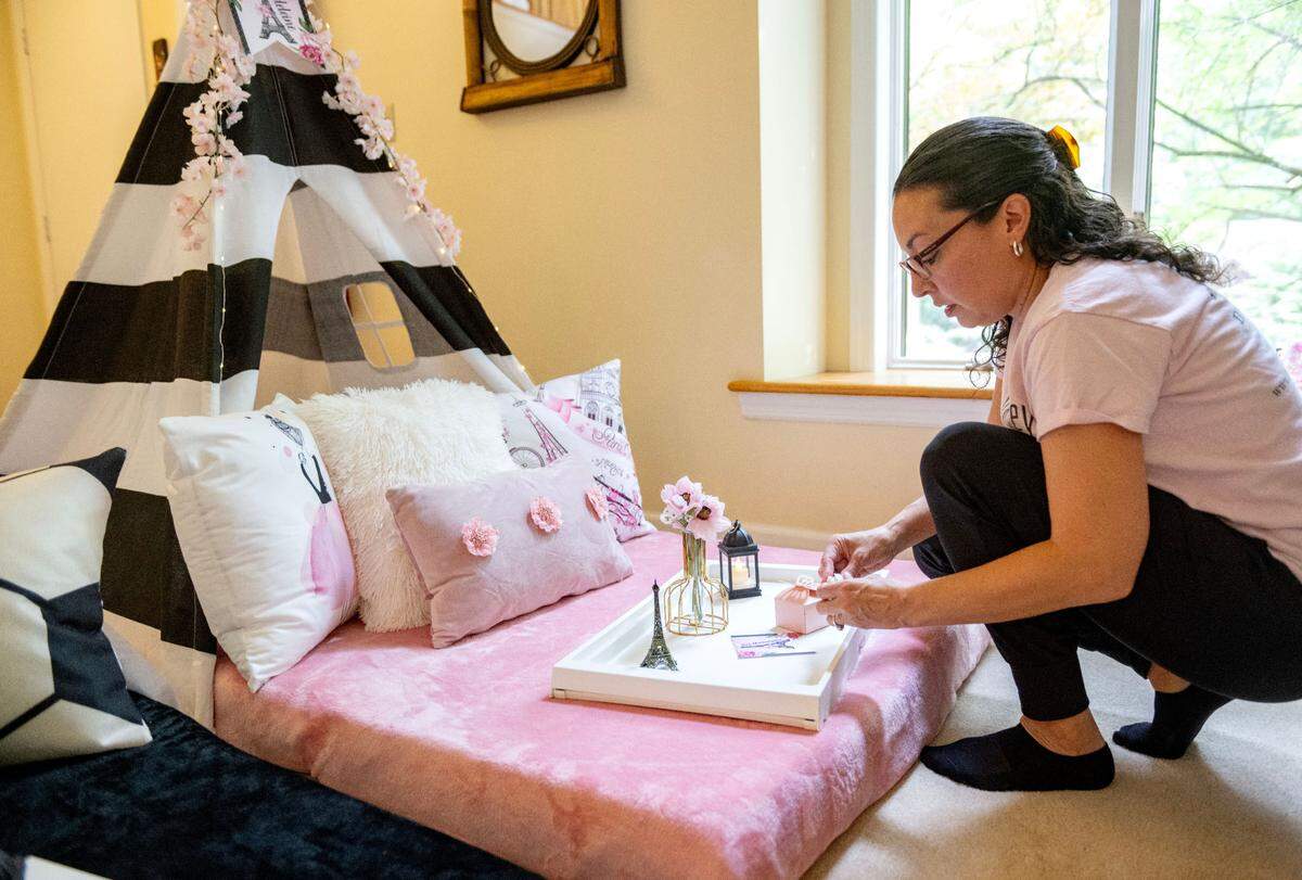 Claudia Prieto of Happy Valley Slumber puts the finishing touches a on a Night in Paris themed set up.