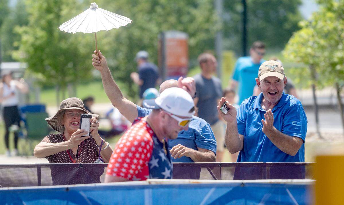 An athlete laughs as he is cheered on during the Ironman 70.3 Pennsylvania Happy Valley on Sunday, June 30, 2024.