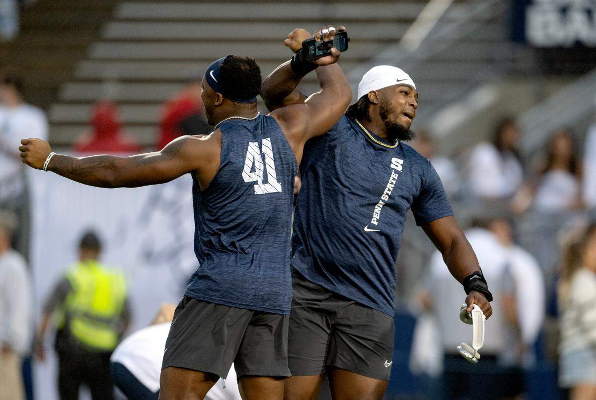 Penn State linebacker Kobe King greets a teammate as they warm up for the Homecoming game on Saturday, Sept. 28, 2024.