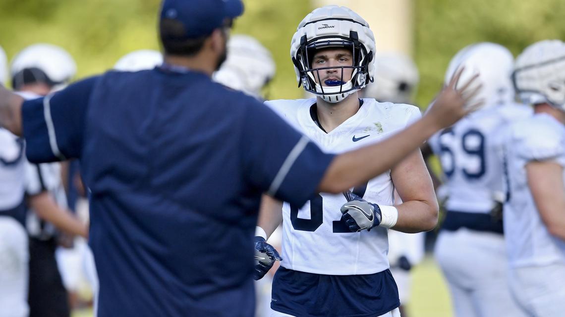 Penn State tight end Pat Freiermuth jogs over to tight ends coach Tyler Bowen after running a play at practice on August 7, 2019.