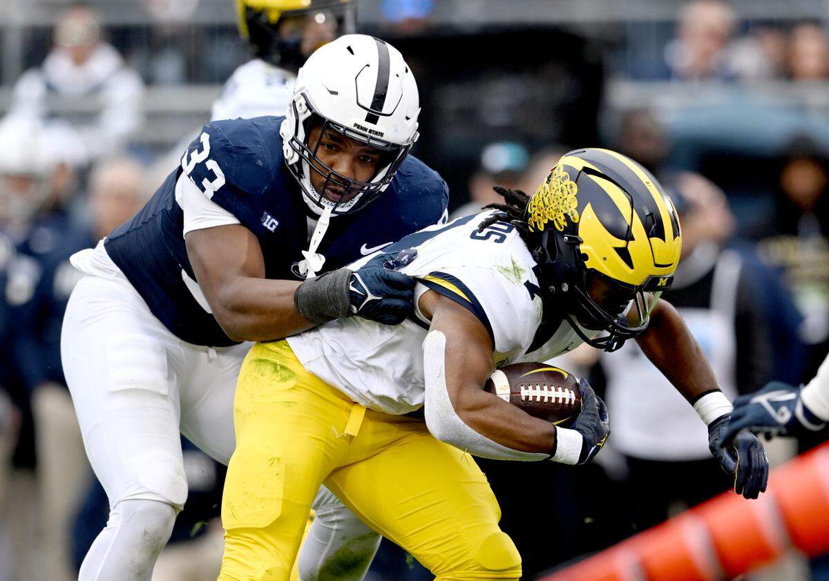 Penn State defensive end Dani Dennis-Sutton stops Michigan’s Donovan Edwards during the game against Michigan on Saturday, Nov. 11, 2023.