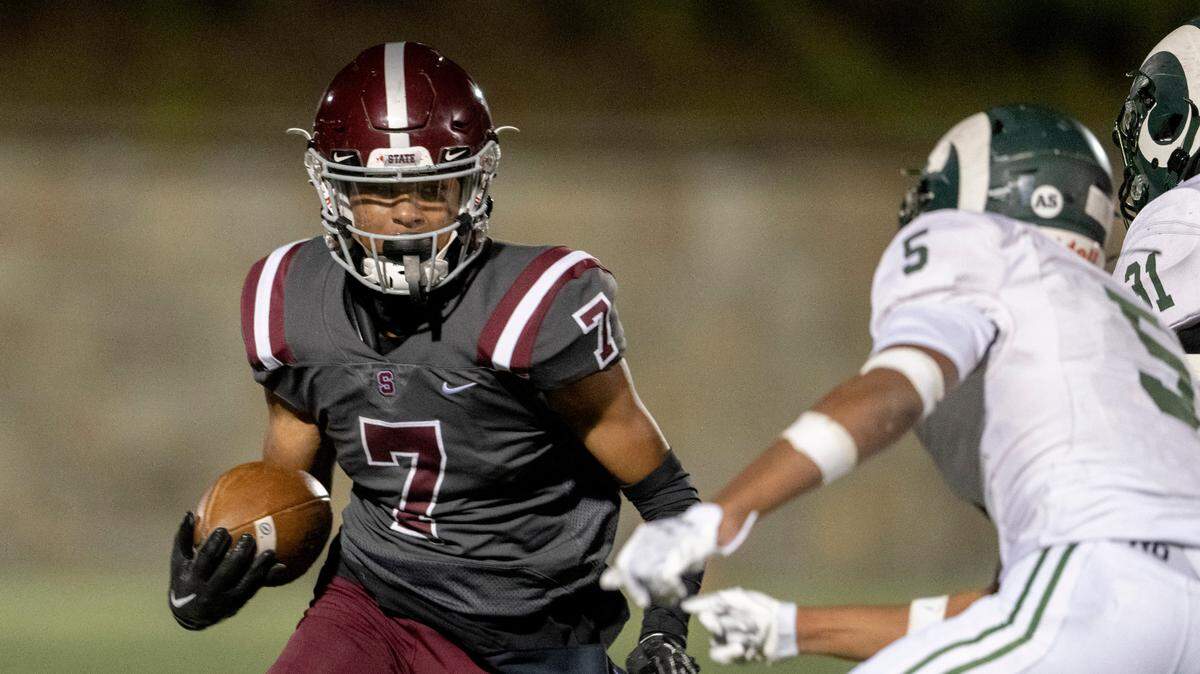 State College’s D’antae Sheffey cuts down he field with the ball from Central Dauphin defenders during the game on Friday, Sept. 23, 2022 at Memorial Field.