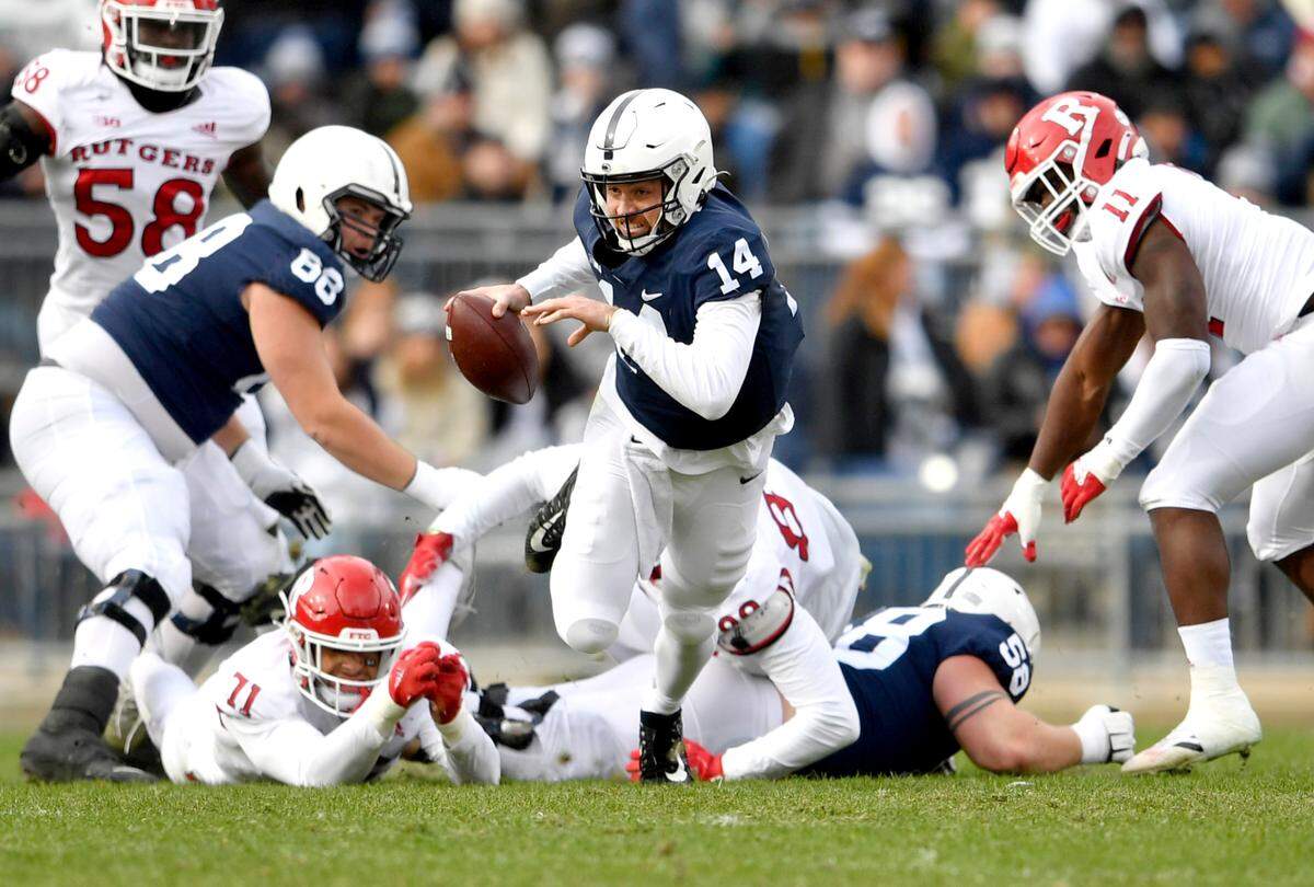 Penn State quarterback Sean Clifford gets tripped up as he tries to run with the ball during the game against Rutgers on Saturday, Nov. 20, 2021. Clifford did not return in the first half of the game after the play.