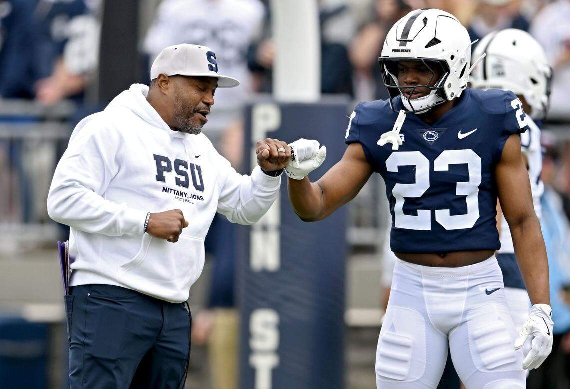 Penn State running backs coach Stan Drayton fist bumps Tikey Hayes during warm-ups for the Blue-White Game on Saturday, April 26, 2025.  