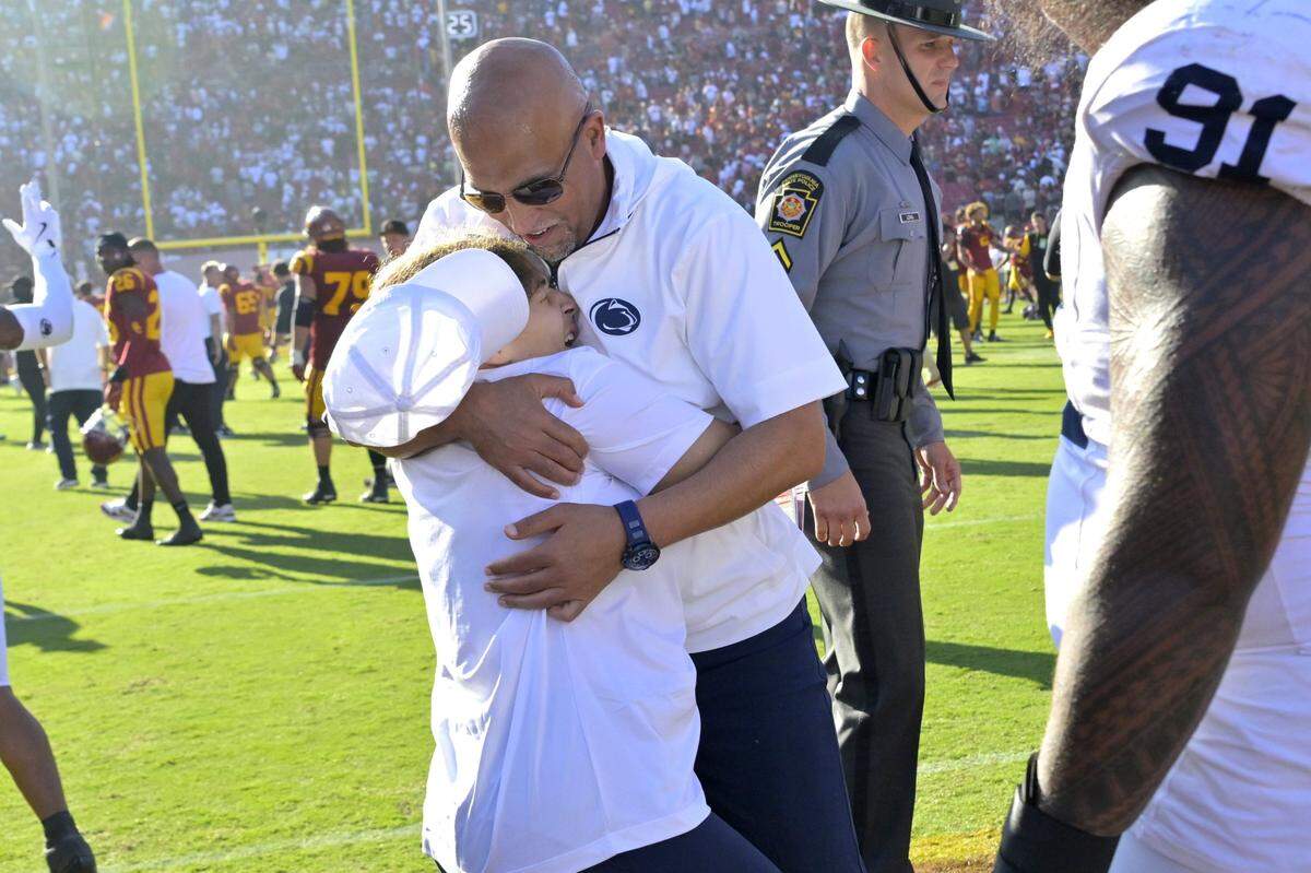 Oct 12, 2024; Los Angeles, California, USA; Penn State Nittany Lions head coach James Franklin is hugged by his daughter Addy after defeating the USC Trojans in overtime at United Airlines Field at the Los Angeles Memorial Coliseum. Mandatory Credit: Jayne Kamin-Oncea-Imagn Images
