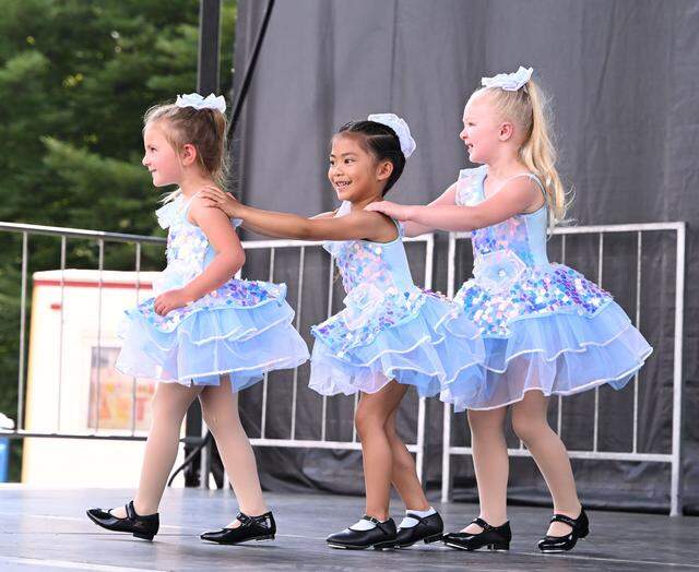 Three youngsters from the Dance Academy of State College entertain onlookers in front of Old Main during Wednesday’s Children and Youth Day at the 57th Central Pennsylvania Festival of the Arts in State College.