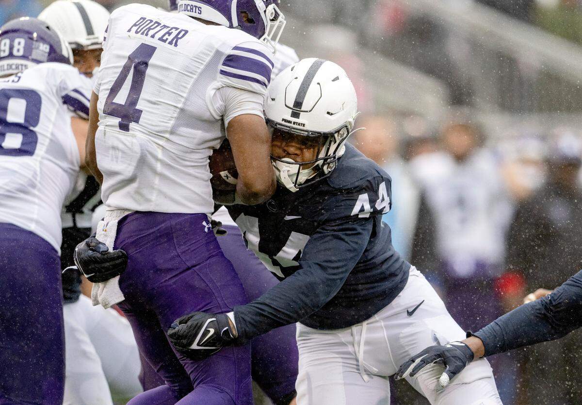 Penn State defensive end Chop Robinson stops Northwestern’s Cam Porter during the game on Saturday, Oct. 1, 2022.