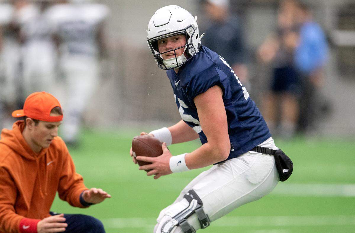 Penn State quarterback Drew Allar drops back with the ball for a drill during spring practice on Wednesday, March 30, 2022.