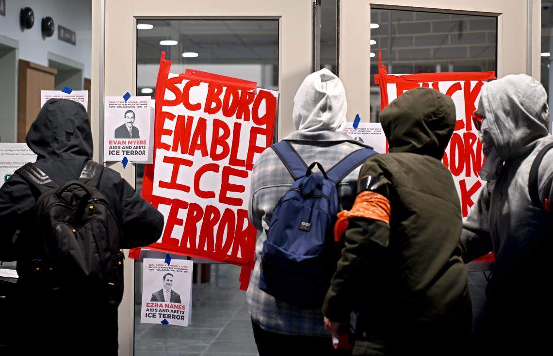 Protesters chant and hang flyers in the vestibule of the State College Municipal building on Monday, April 20, 2026.  